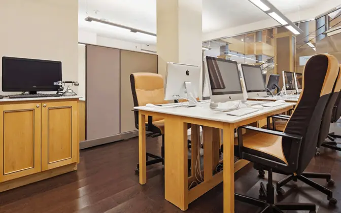 Business center inside the Florida Mall featuring Mac computers and workspace.