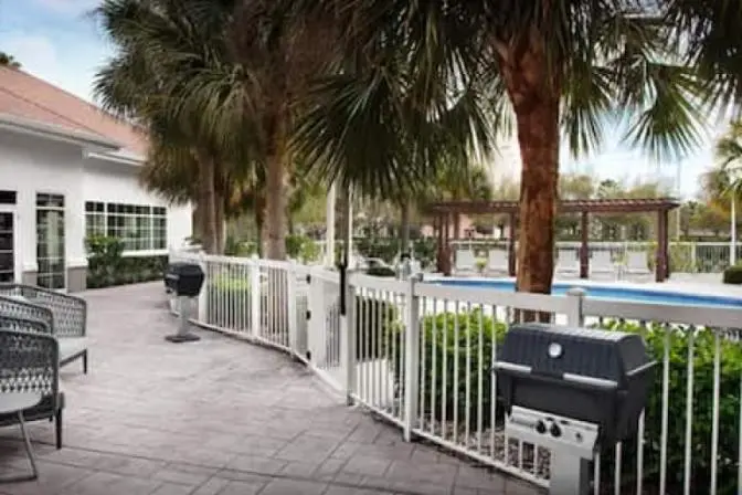 Outdoor patio featuring bbq's near the outdoor swimming pool.