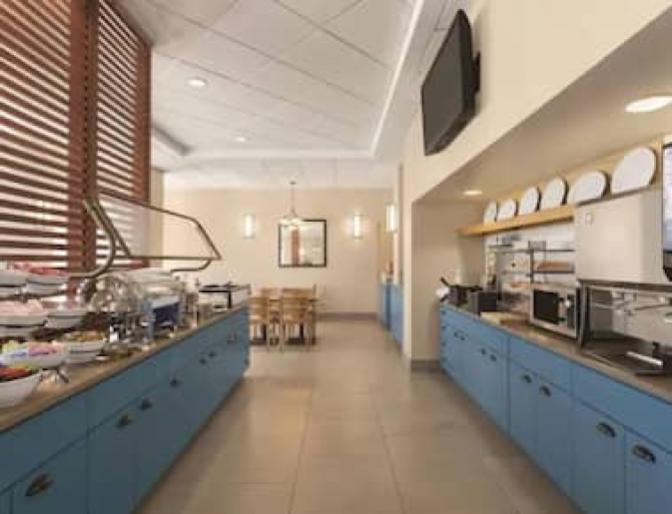 Buffet style dining area featuring a long hallway of self serve hot and cold breakfast items.
