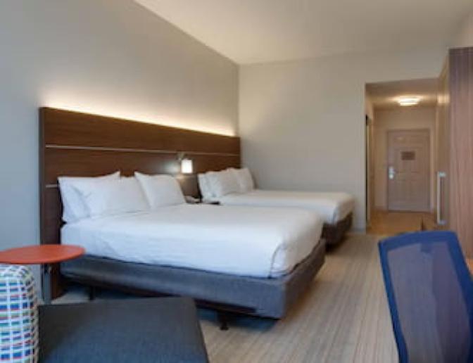 A room that has two Queen beds at the Holiday Inn Express Orlando International Airport hotel.