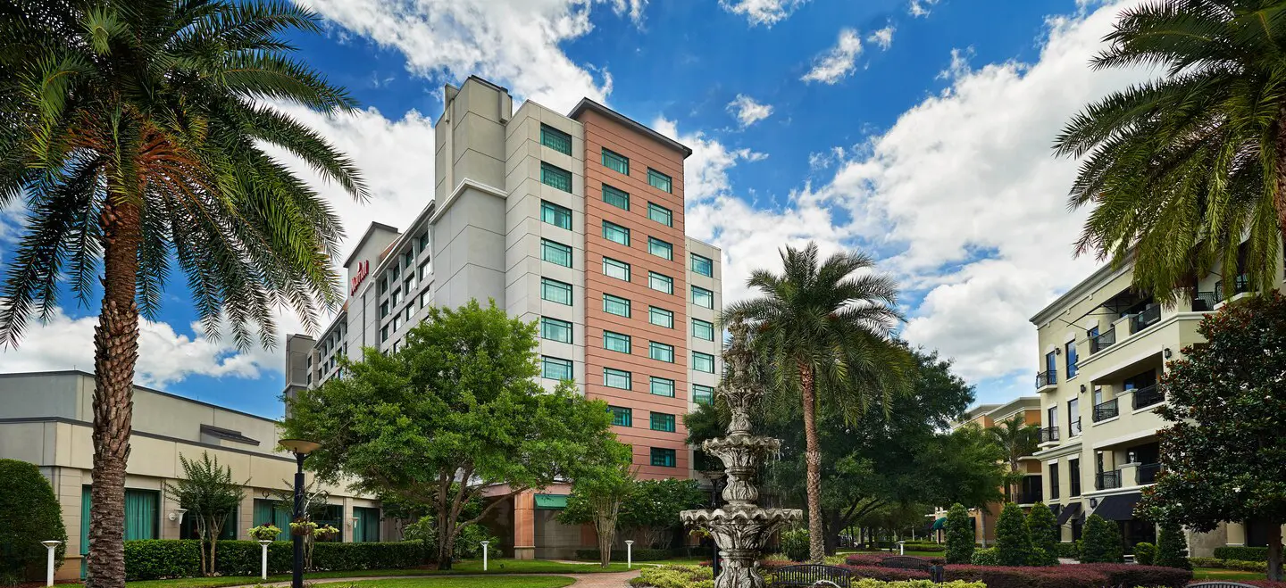 Exterior view of Orlando Marriott Lake Mary featuring a large multi-story building with lush greenery.