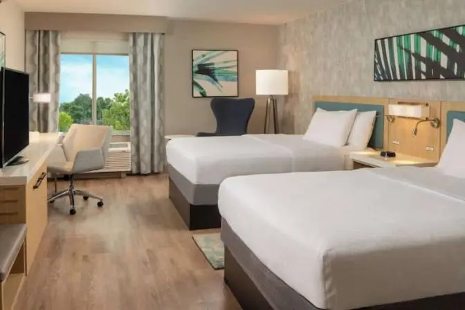 Elegant hotel room with a queen bed, modern decor, and convenient amenities for a comfortable stay.