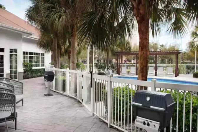 Outdoor patio featuring bbq's near the outdoor swimming pool.
