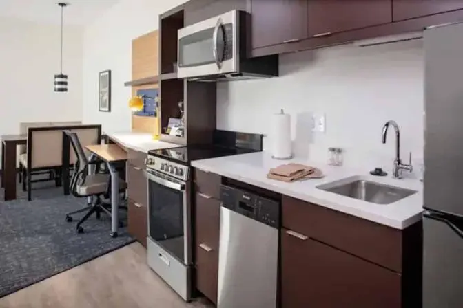 A room that has a kitchenette in TownePlace Suites near Orlando Airport.
