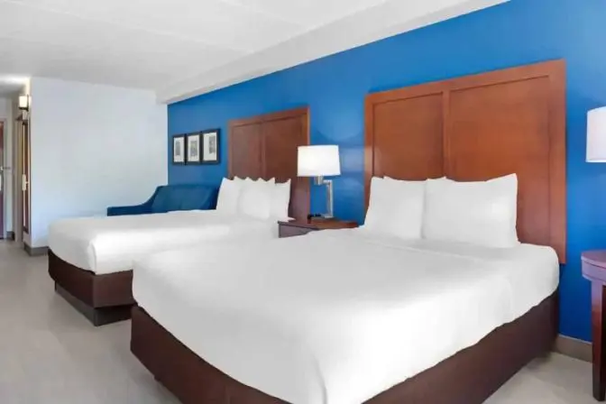 Spacious hotel room with two queen beds and contemporary furnishings at Comfort Inn & Suites.