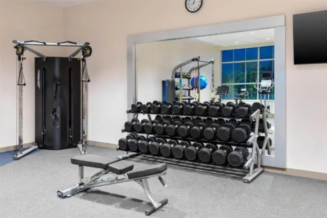 Hotel fitness center with treadmills, rowing machine, and strength training equipment at Hilton Garden Inn Cape Canaveral near Cocoa Beach.
