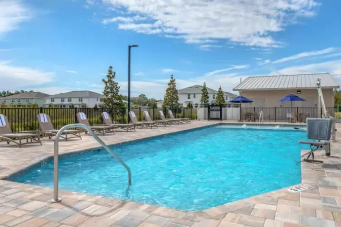 Comfort Inn & Suites Sanford featuring an outdoor swimming pool in the sun.