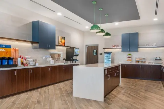 Buffet area featuring coffee, juice, and multiple food options.