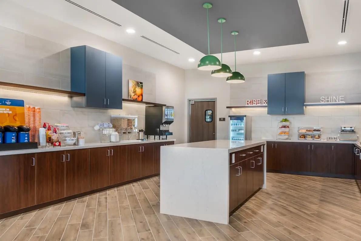 Buffet area featuring coffee, juice, and multiple food options.