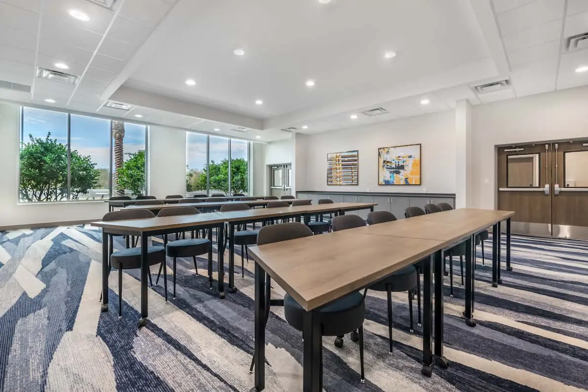 Comfort Inn & Suites Sanford featuring one of the communal meeting areas, with long tables and a window view.