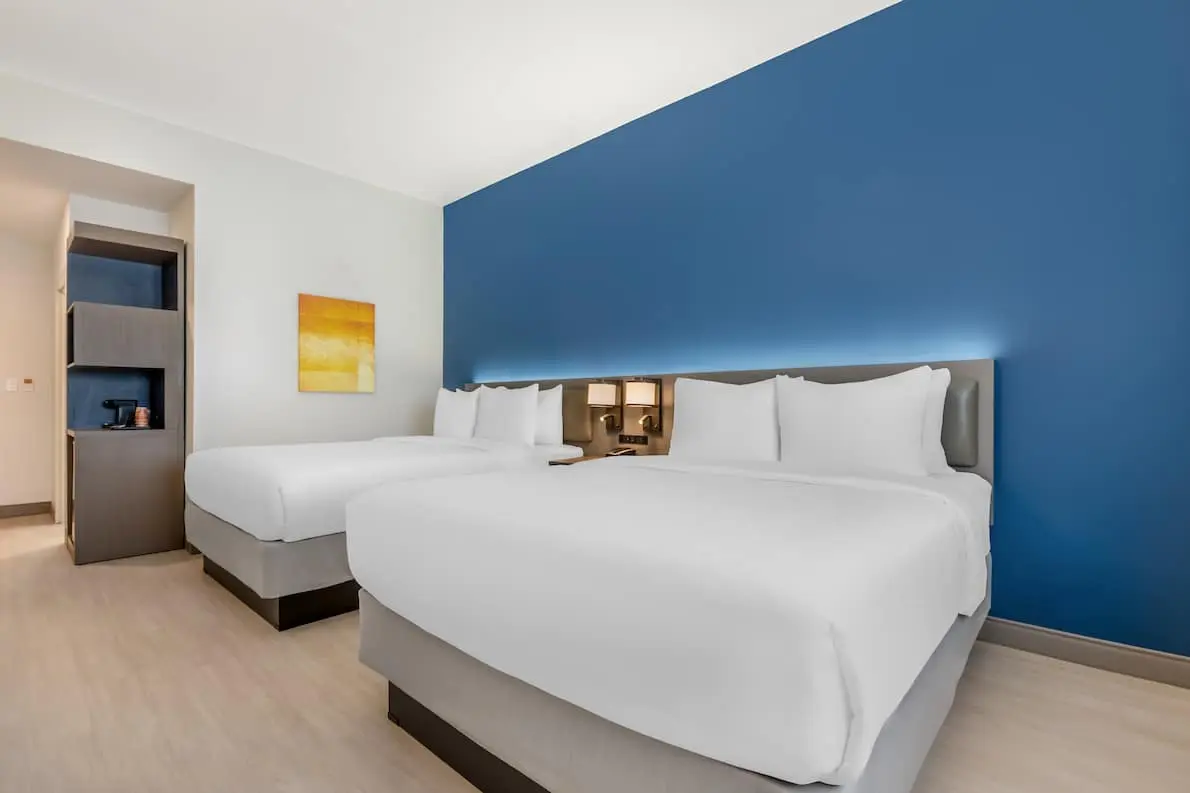Spacious hotel room with two queen beds and modern furnishings at Comfort Inn & Suites.